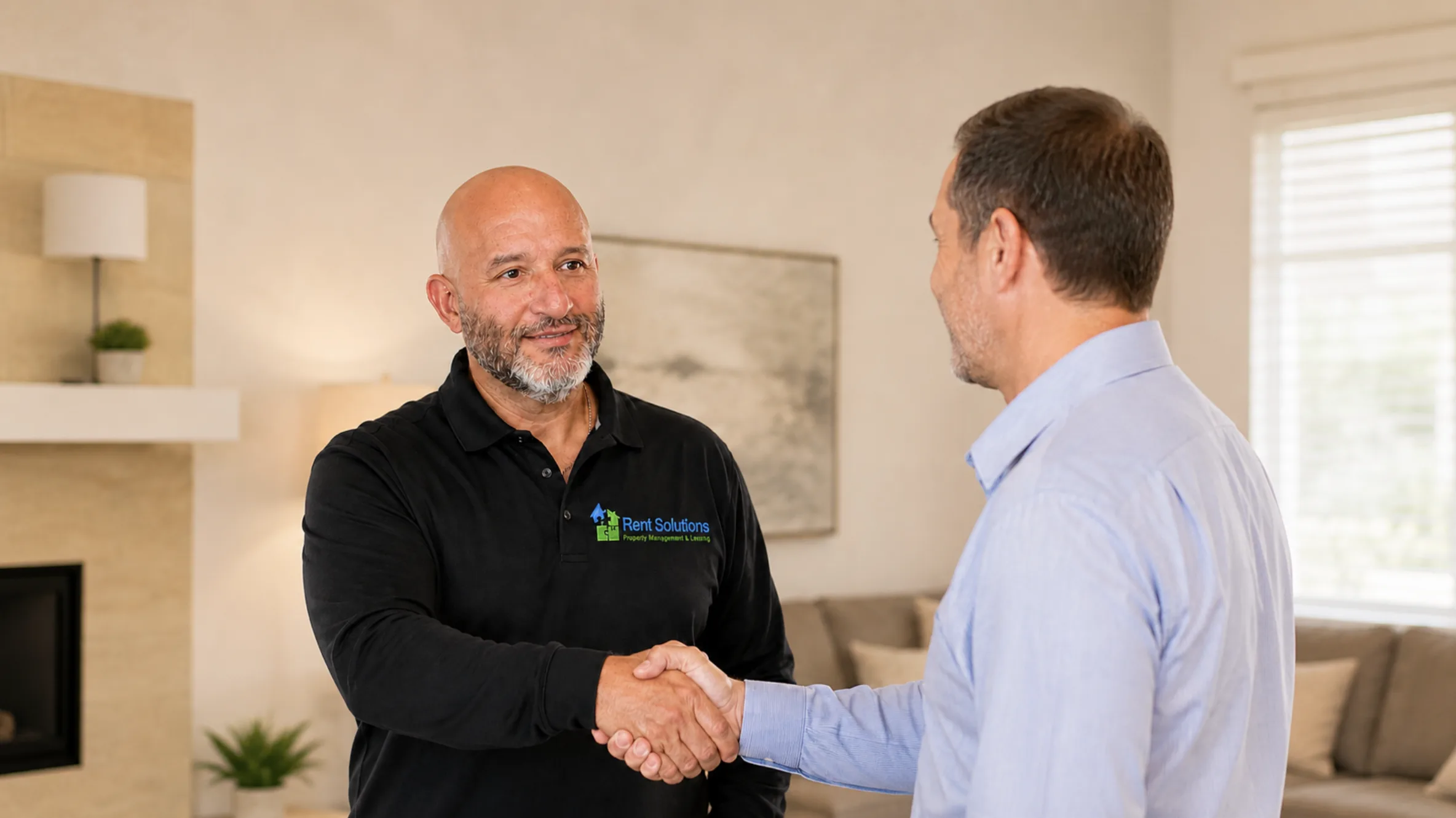 Rent Solutions property manager in branded polo shaking hands with a property owner